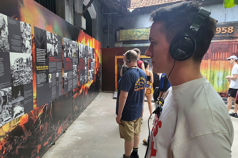 Visitors are listening to stories about Hoa Lo Prison.